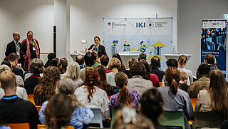 Rear view of a full audience during a lecture.