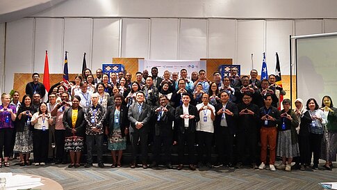 Participants in a regional exchange pose for a photo.