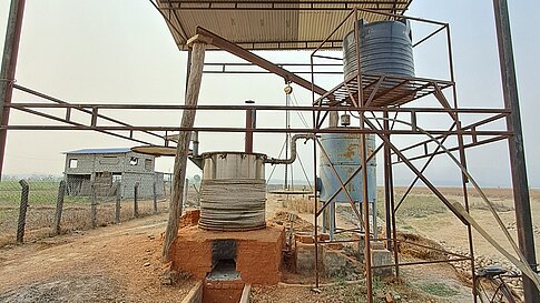 Distillation unit for essential oils with metal structure and water tank.