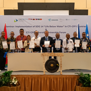 Participants pose after the signing ceremony.