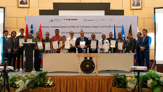 Participants pose after the signing ceremony.