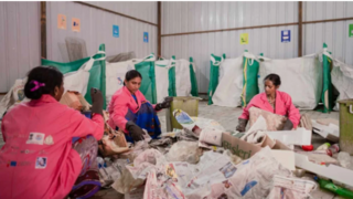 Indian women sort trash for recycling 