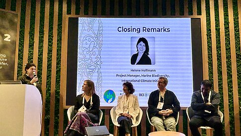 A women delivers her closing remarks at an event.