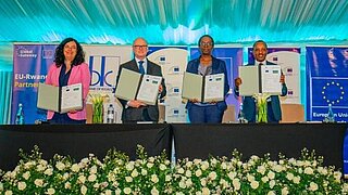 Four people standing on a stage. 