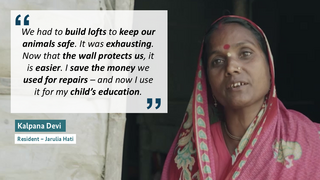 Kalpana Devi, wearing a colorful sari and headscarf, shares how building lofts to protect animals was exhausting before the wall was built. Now, she uses the saved repair money for her child’s schooling.