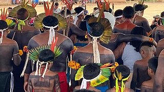 Indigenous people in Brazil dancing, photographed from behind