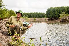 Person sitting at river bank