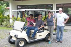 Four people in front of a solar car