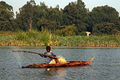 Fisherman in a papyrus boat at a lake
