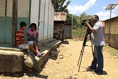 Person photographing two children