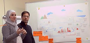 Two workers wearing safty helmets cleaning solar panels on a rooftop 