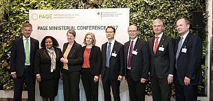 Two workers wearing safty helmets cleaning solar panels on a rooftop 