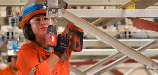 Female worker assembling the automatically positioned mirrors of the Concentrated Solar Power plant in Calama, Chile