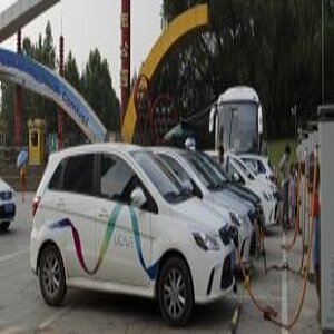 Several small electric cars at a charging station in China