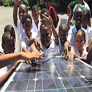 Group of children standing at a solar panel