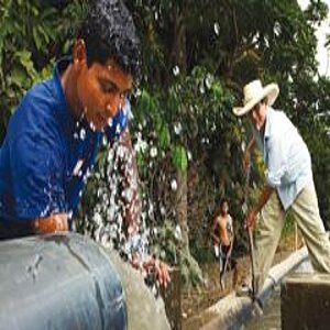 Two workers at an artificial water channel