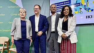 Four people in a group photo: two men and two women