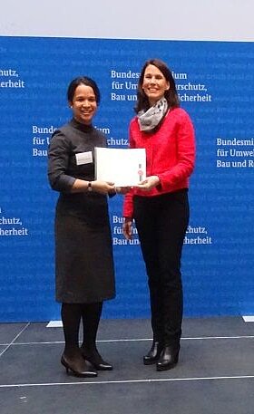 Two women are holding a certificate