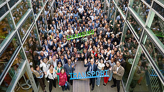 A group of people wave at the camera.  